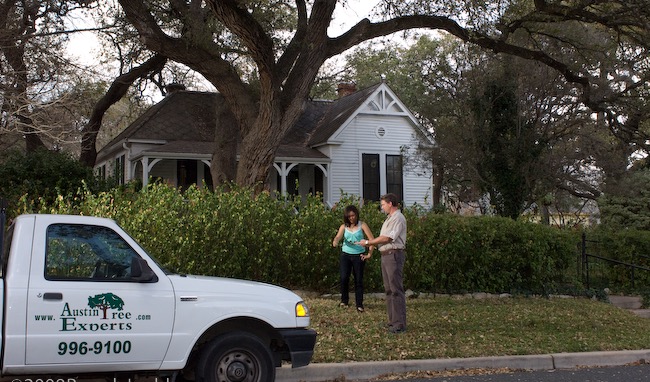 Austin Tree Experts arborist meeting with customer at branded company truck