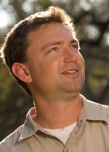 ISA Certified Arborist at Austin Tree Experts evaluating tree condition during a property assessment