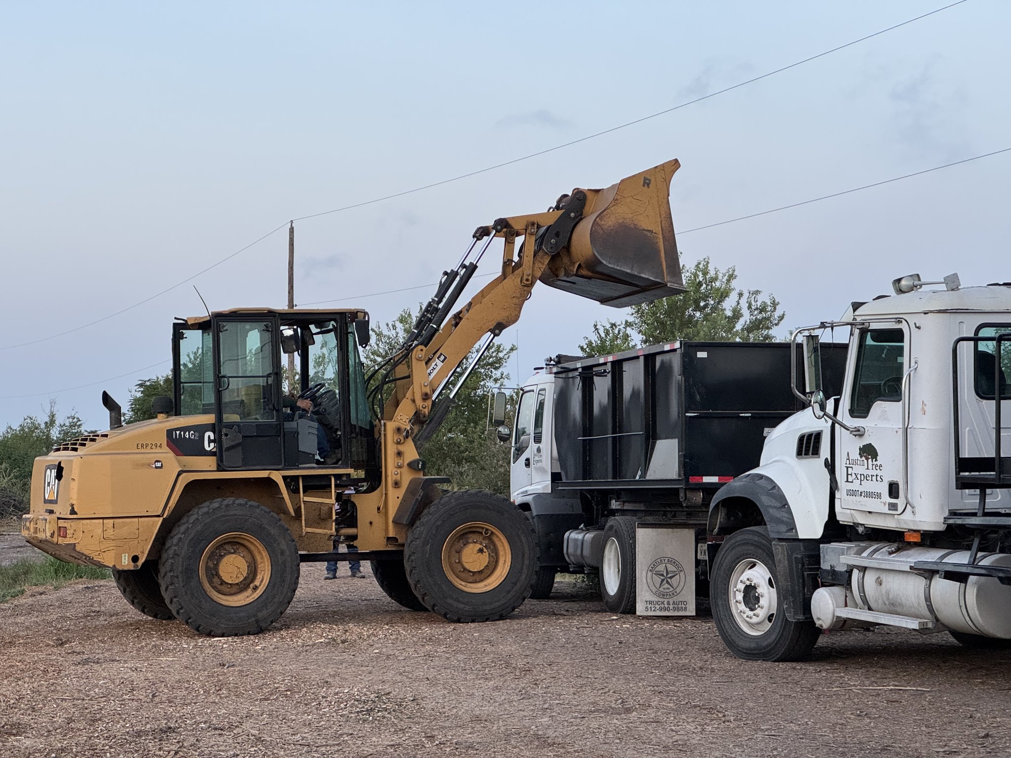 Loader at Austin Tree Experts composting facility processing mulch
