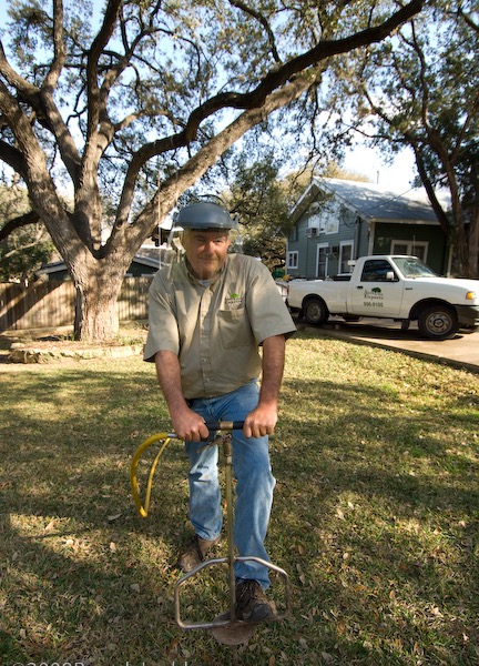 Certified arborist applying a soil injection treatment to a tree showing decline at an Austin home