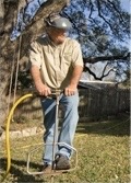 Austin Tree Experts performing a fertilizer treatment on a residential property