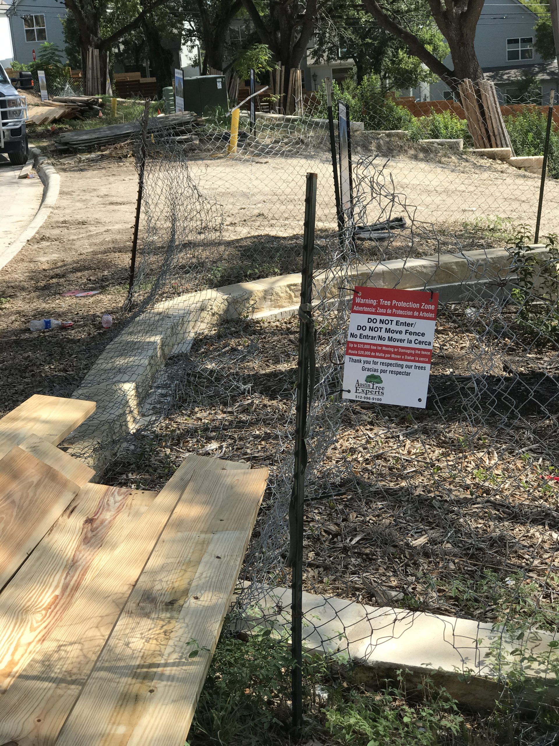 Austin Tree Experts tree protection fencing with signage at construction site
