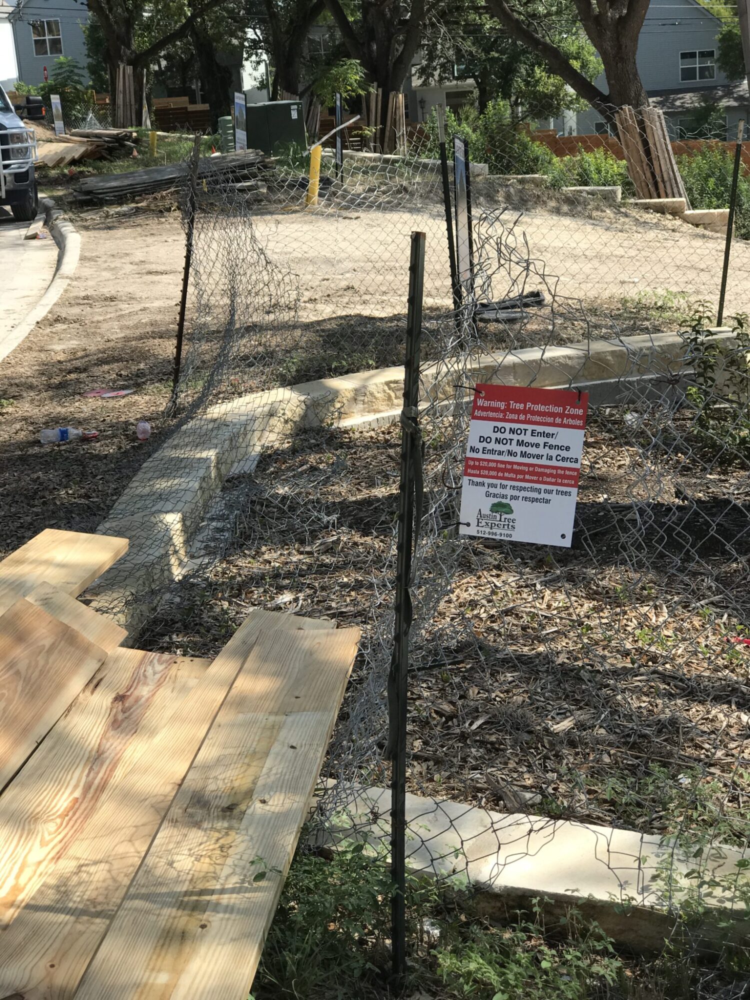 Austin Tree Experts tree protection fencing with signage at construction site