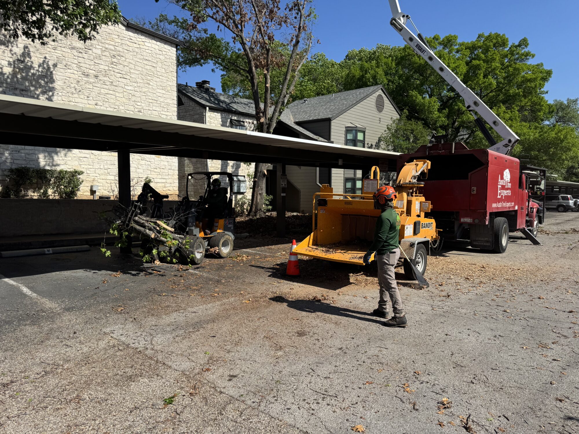 Austin Tree Experts crew with chipper and bucket truck on a residential pruning job